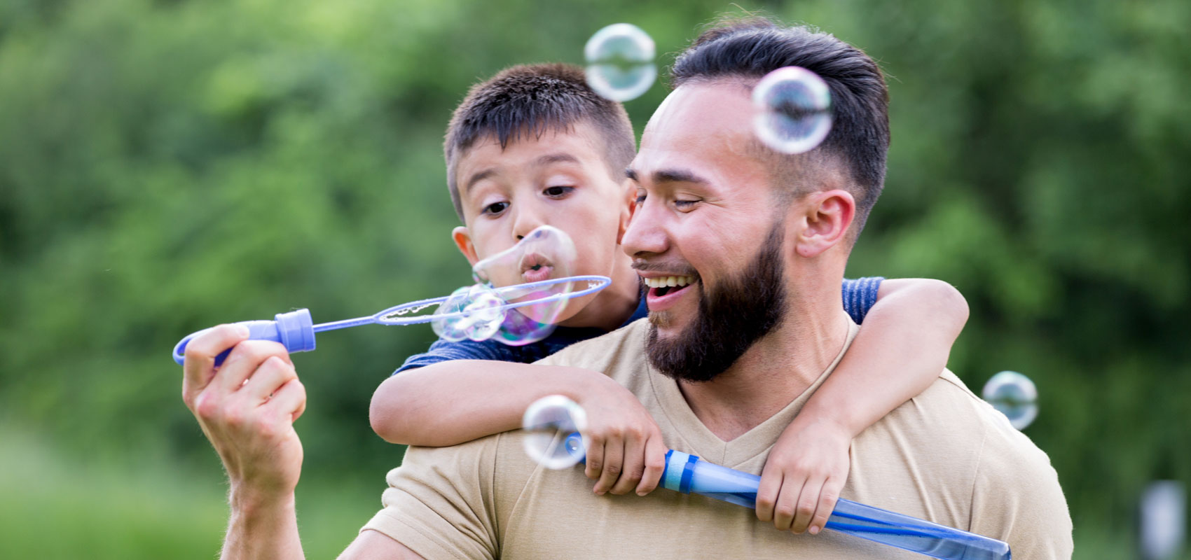 Father and son blowing bubbles